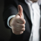 Satisfied customer giving a thumbs up after investing in managed farmland